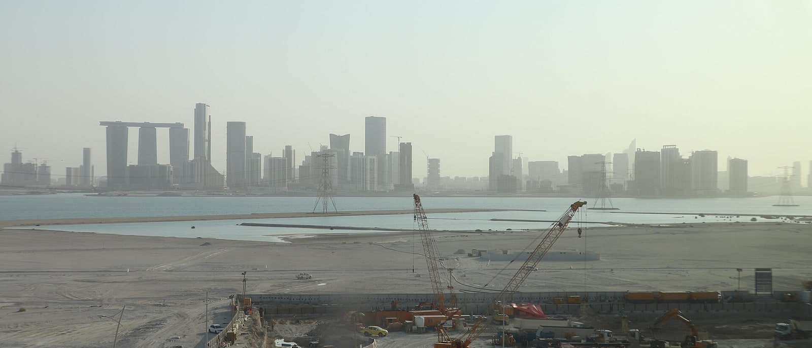 The central island's skyline, cranes and cleared ground in the foreground