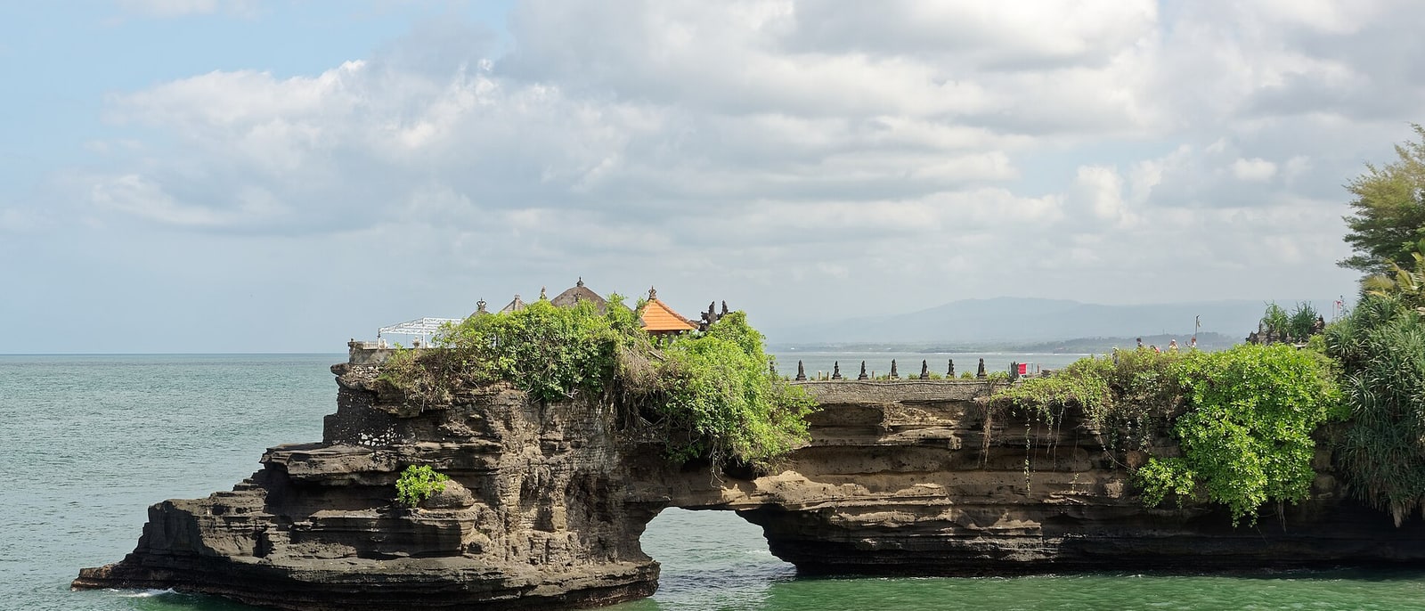 Batu Bolong temple on its rock arch, next to Tanah Lot