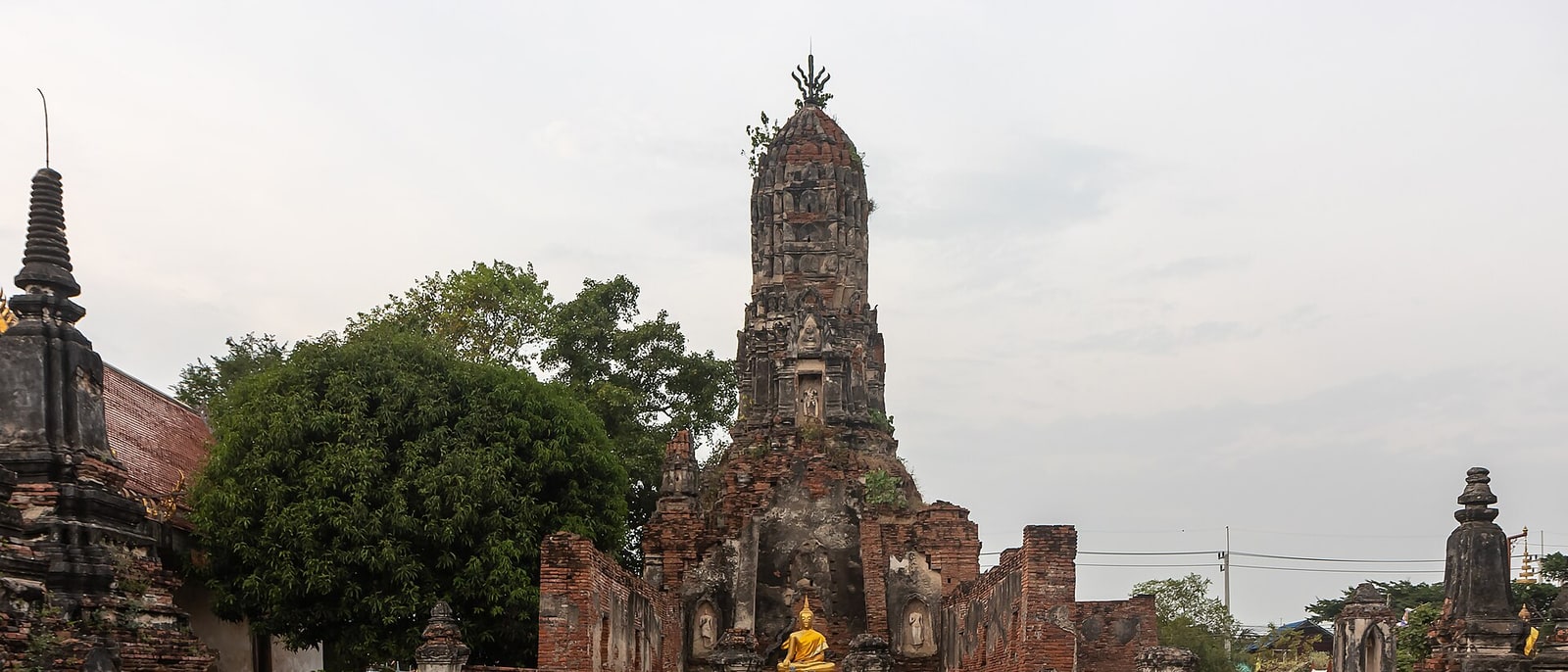 The brick ruins of Ayutthaya: the central prang with a gilded Buddha at its base