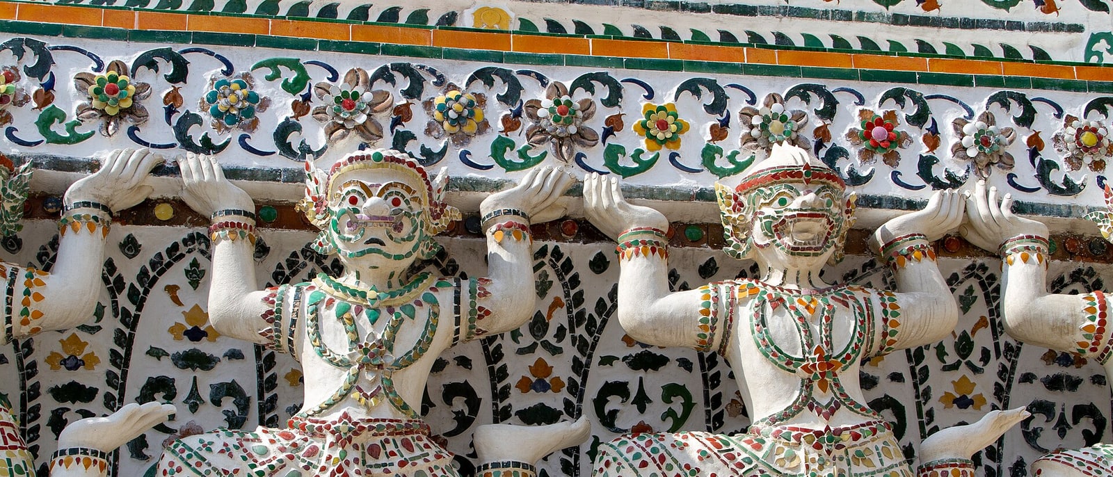 The yakshas holding up the Wat Arun tower, clad in broken Chinese porcelain: the flowers are bits of plate and teacup