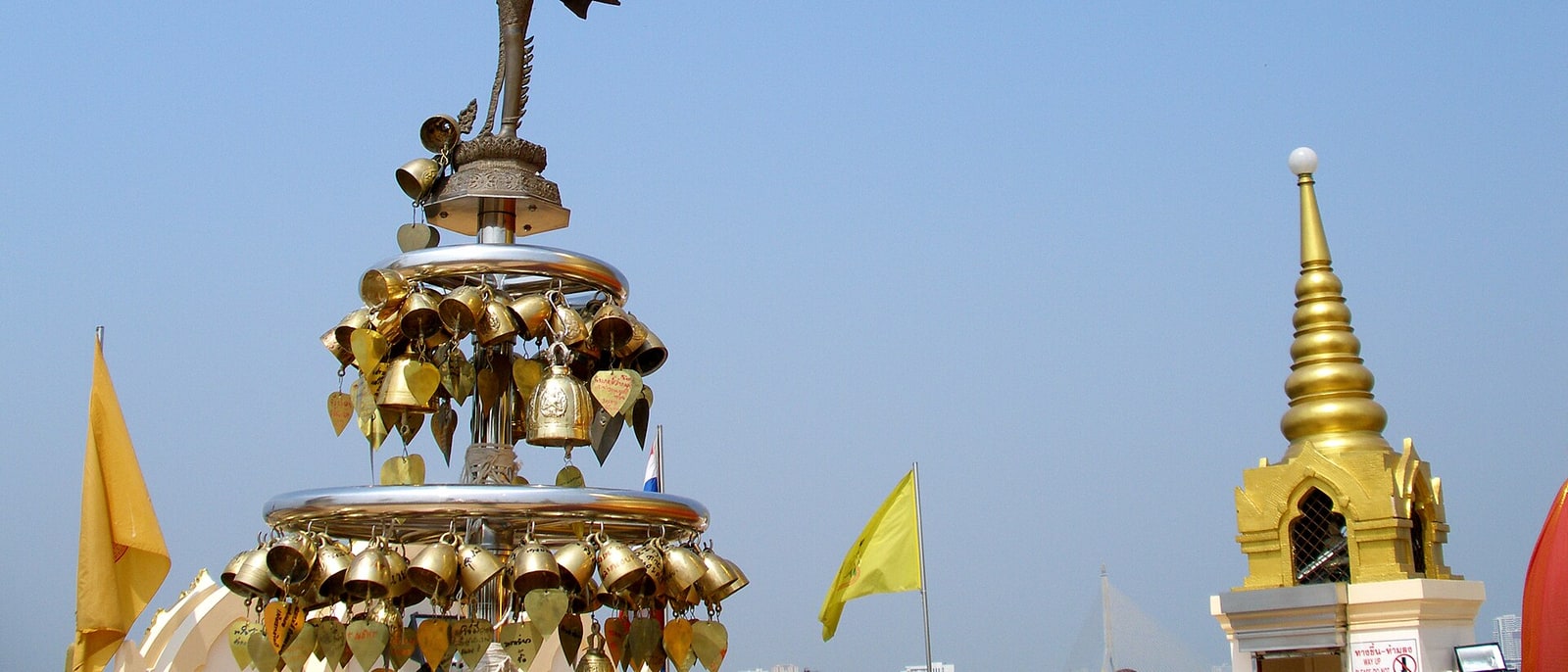 The brass bells at Wat Saket’s Golden Mount, with the stupa spire behind