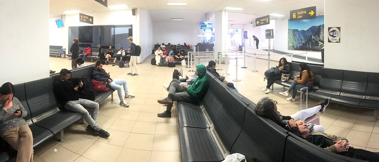 The waiting area of Cusco airport, passengers seated