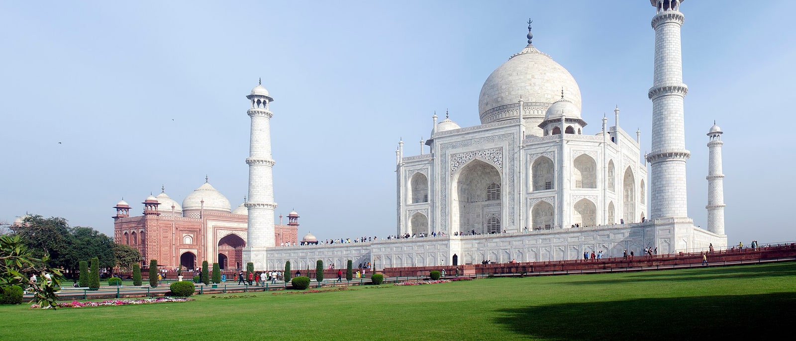 The whole Taj Mahal from the gardens, its sandstone mosque alongside