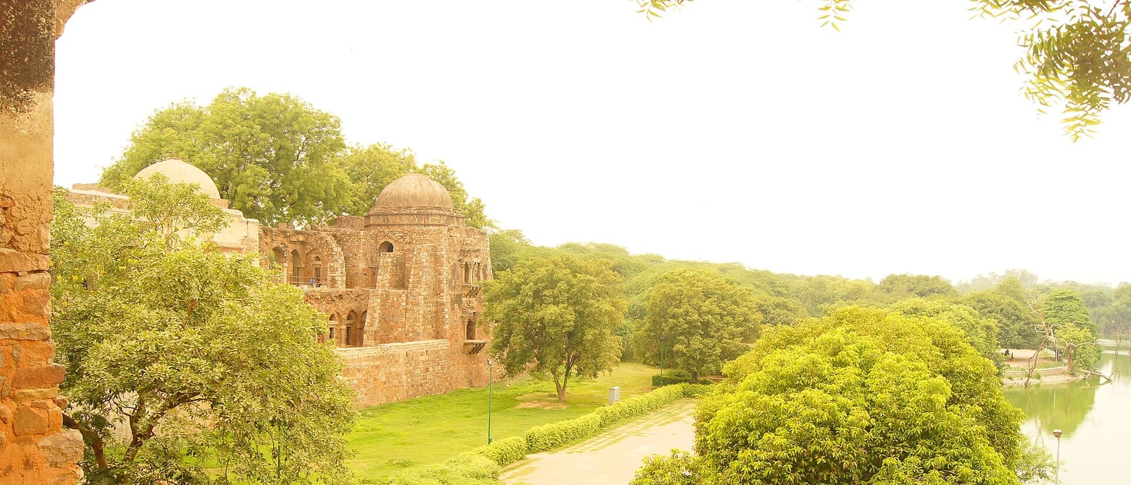 The Hauz Khas ruins beside the tank, among trees