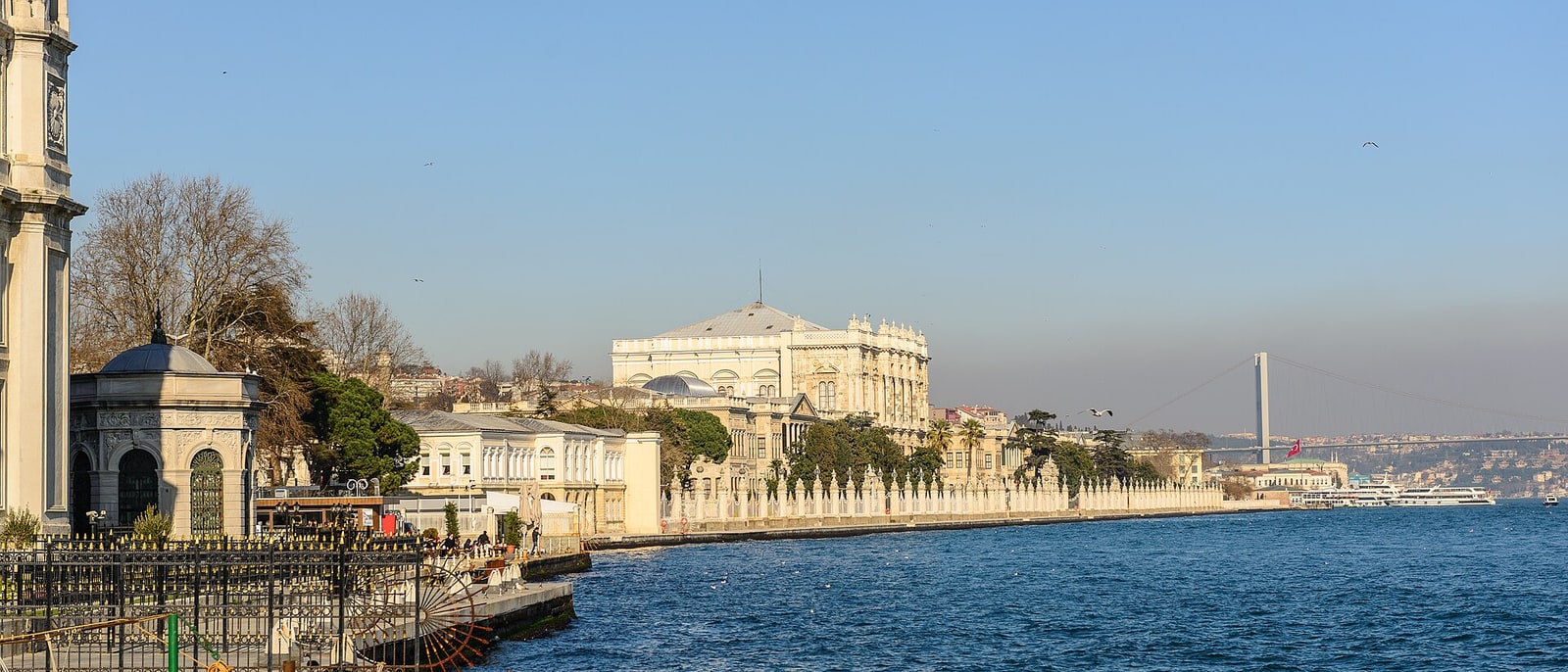 Dolmabahçe Palace from the water, the Bosphorus bridge behind