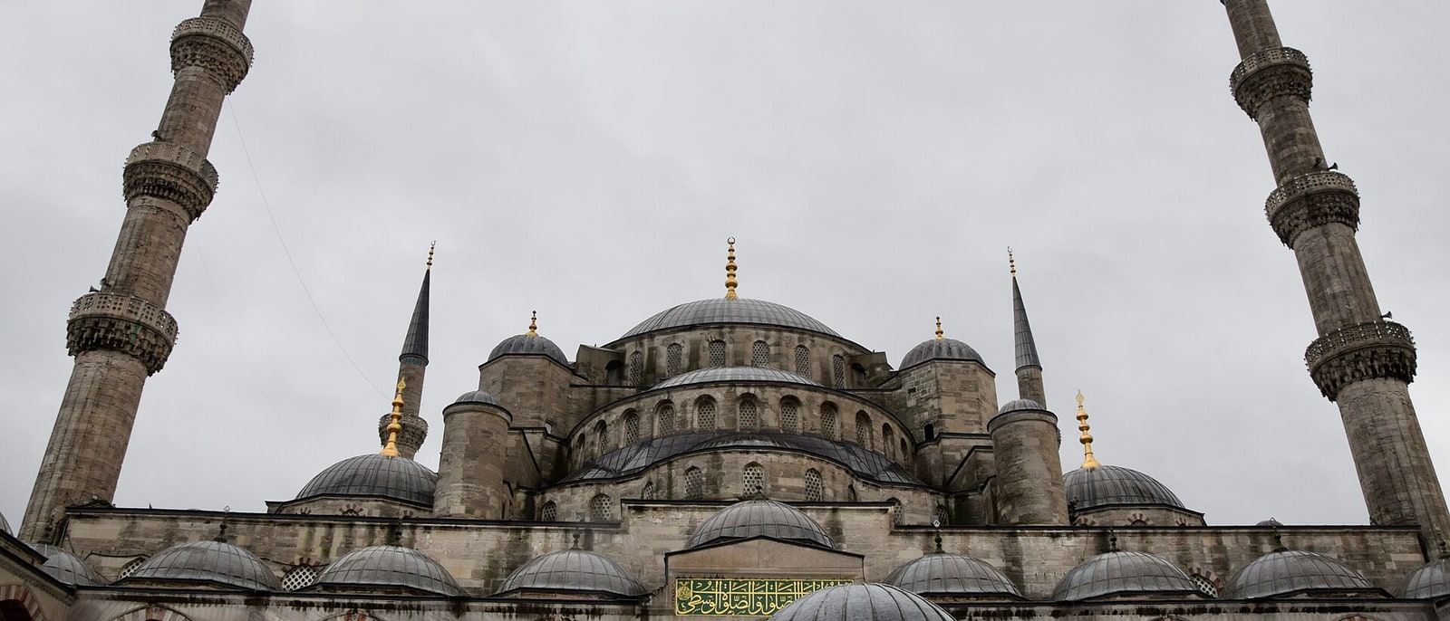 The stepped domes of the Blue Mosque under an overcast sky