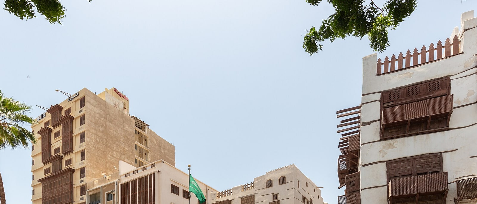 The coral houses of Al-Balad, with the Saudi flag