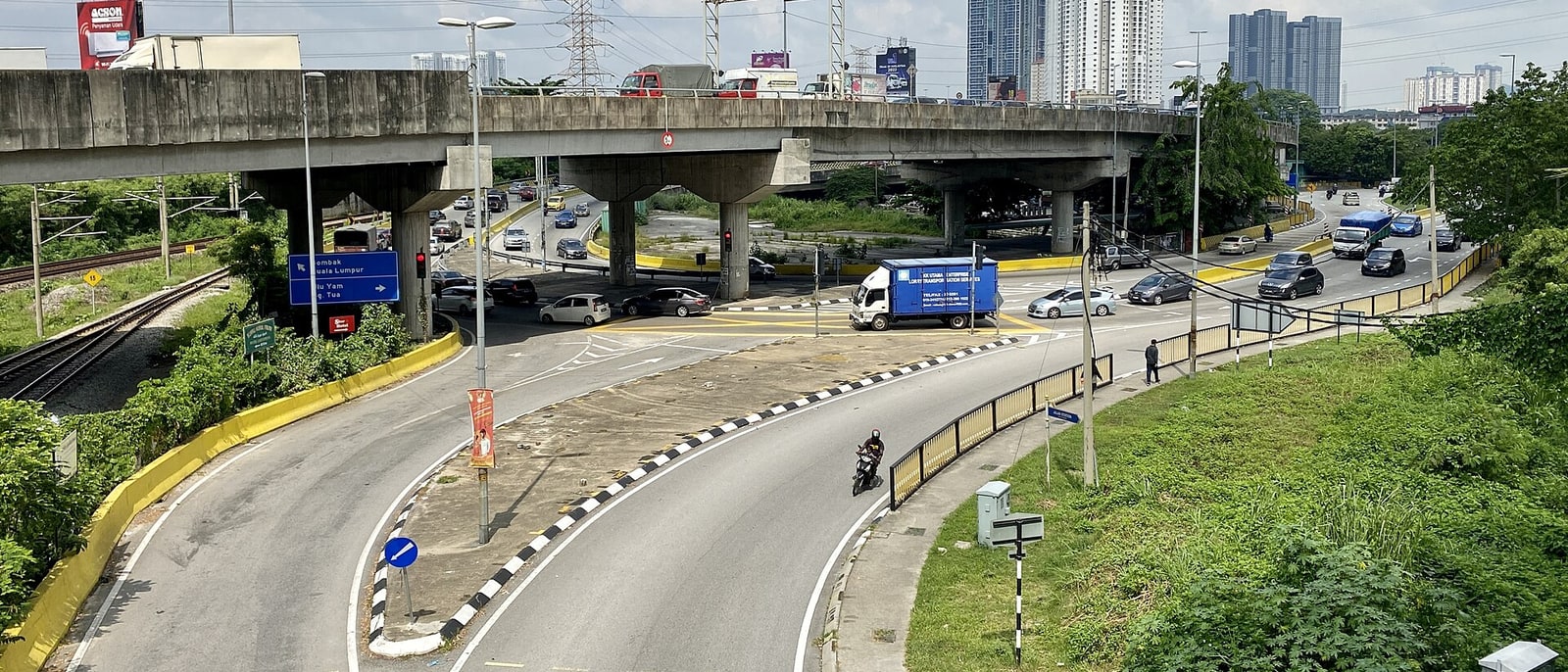 The approach road to Batu Caves, temples in the distance