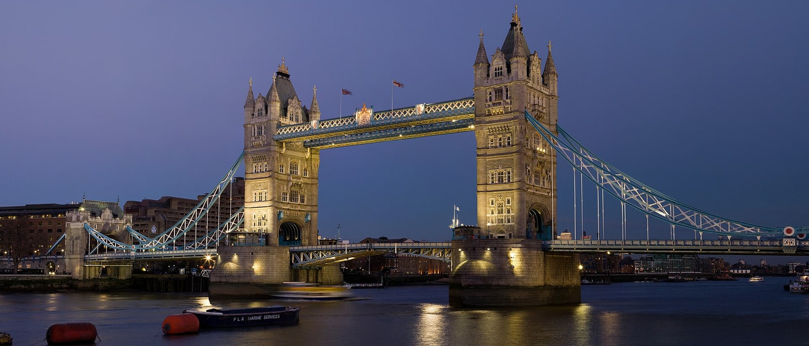 Tower Bridge at dusk, lit above the Thames