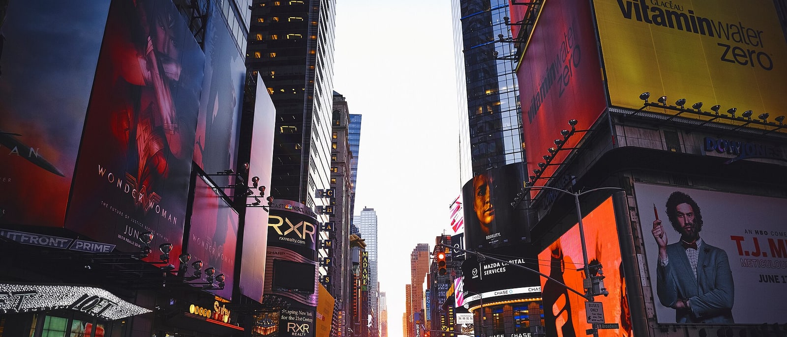 Times Square, screens blazing at sunset