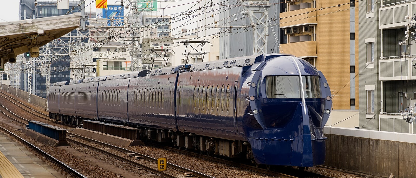 The Nankai Rapi:t train, blue and round-nosed, on the track