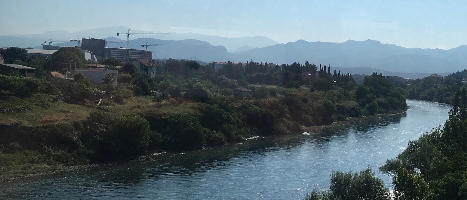 The Morača cutting through Podgorica, mountains behind