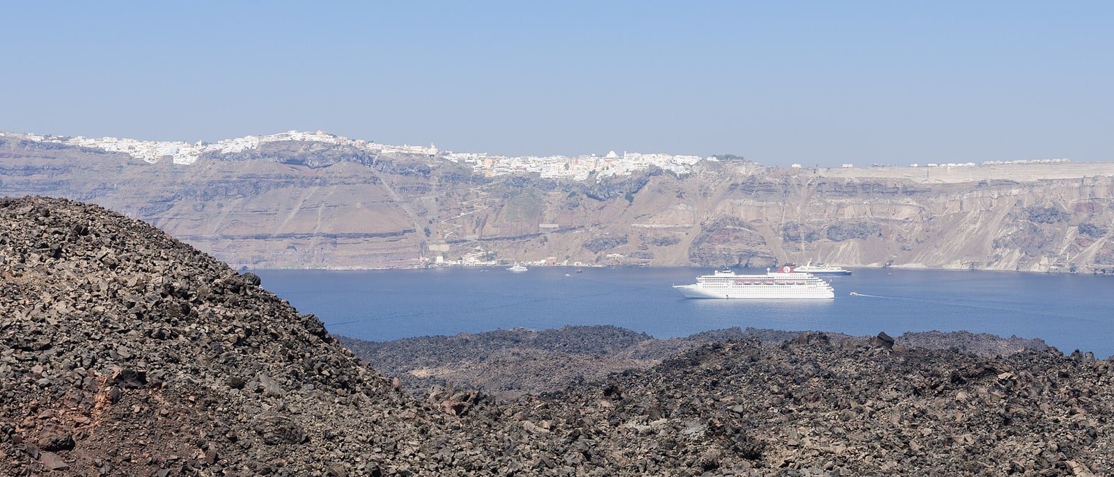 The black lava of Nea Kameni, the caldera rim opposite