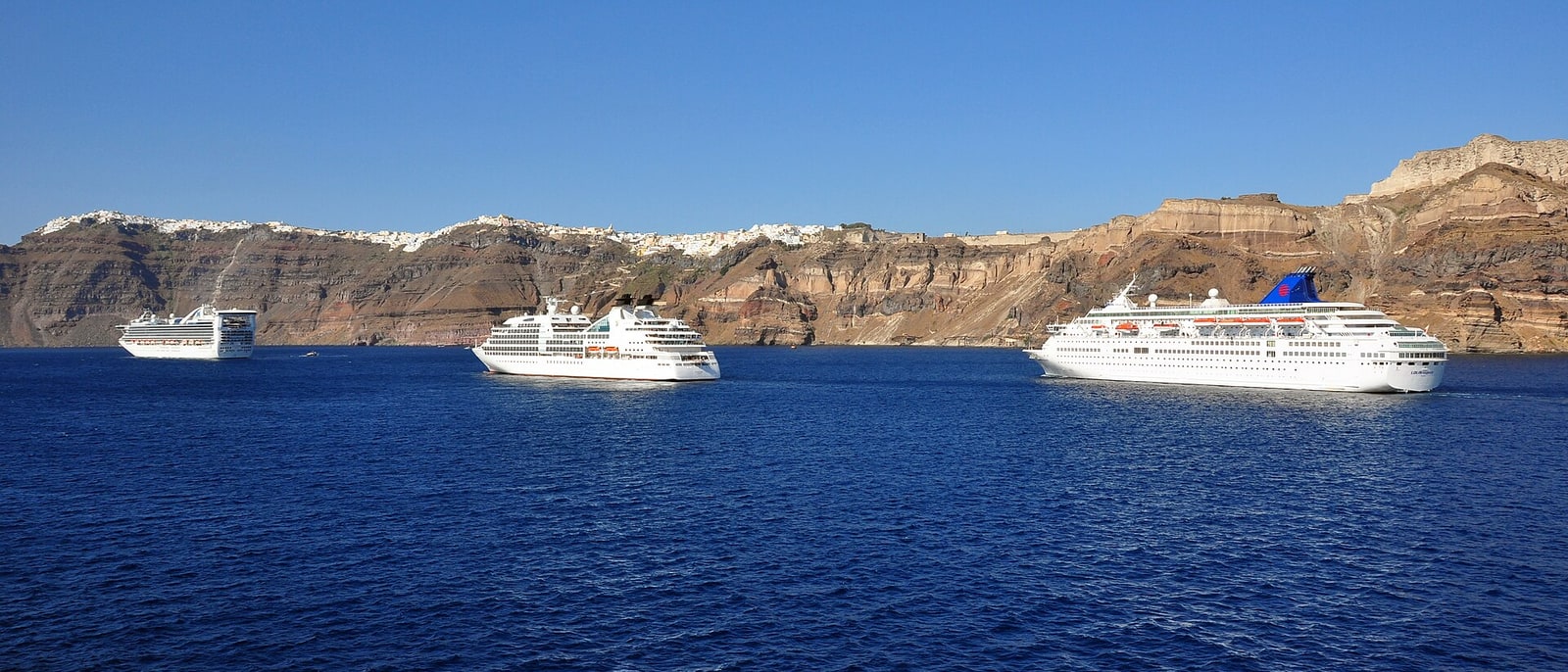Three cruise ships anchored in the caldera at once