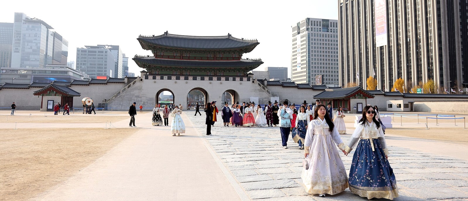 The gate of Gyeongbokgung palace, with visitors in hanbok