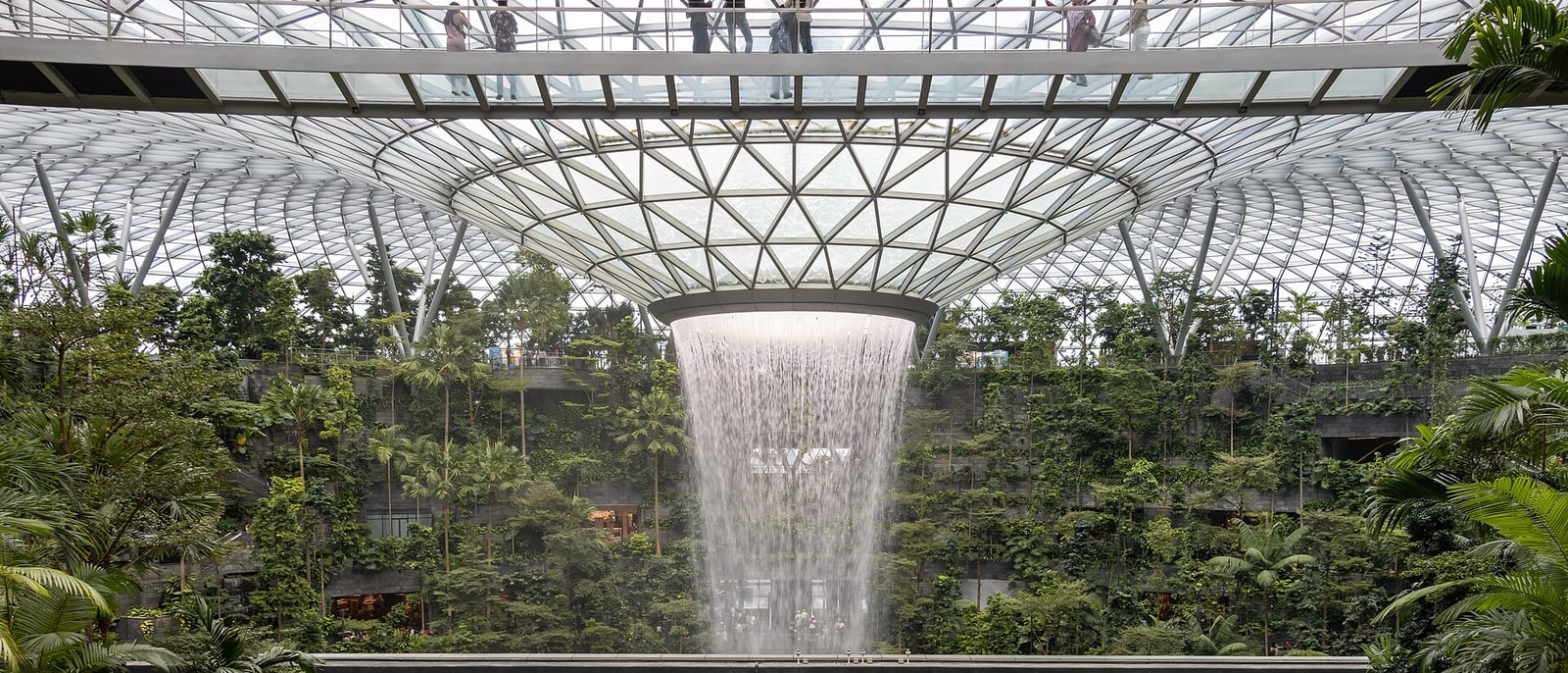 The indoor waterfall at Jewel Changi falling under the glass dome