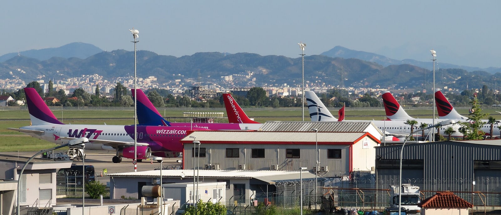 Aircraft on the apron at Tirana airport, mountains behind