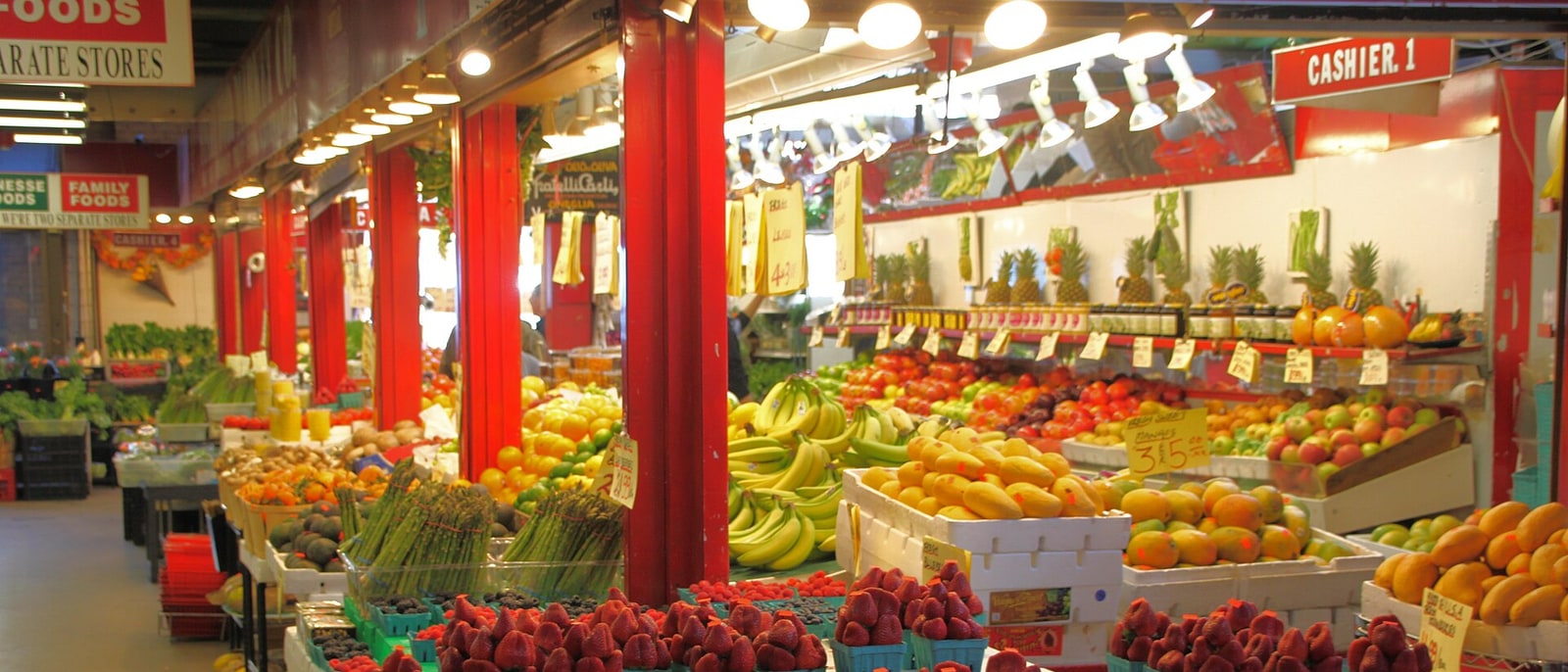 A fruit and vegetable stall inside St Lawrence Market, its crates stacked up