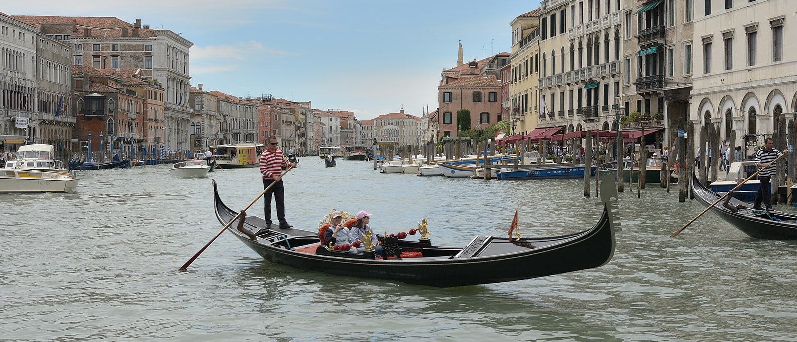 A gondola with its gondolier standing, on the Grand Canal