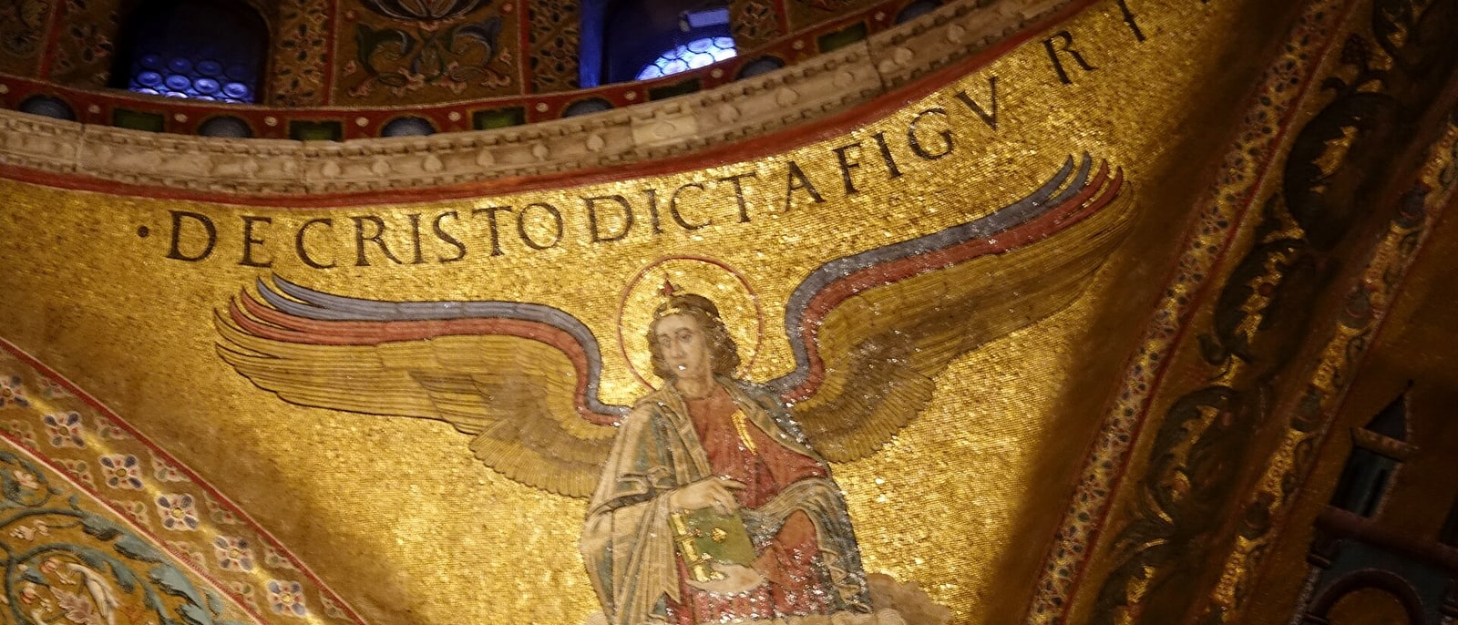 A gold mosaic angel with Latin lettering, inside St Mark’s