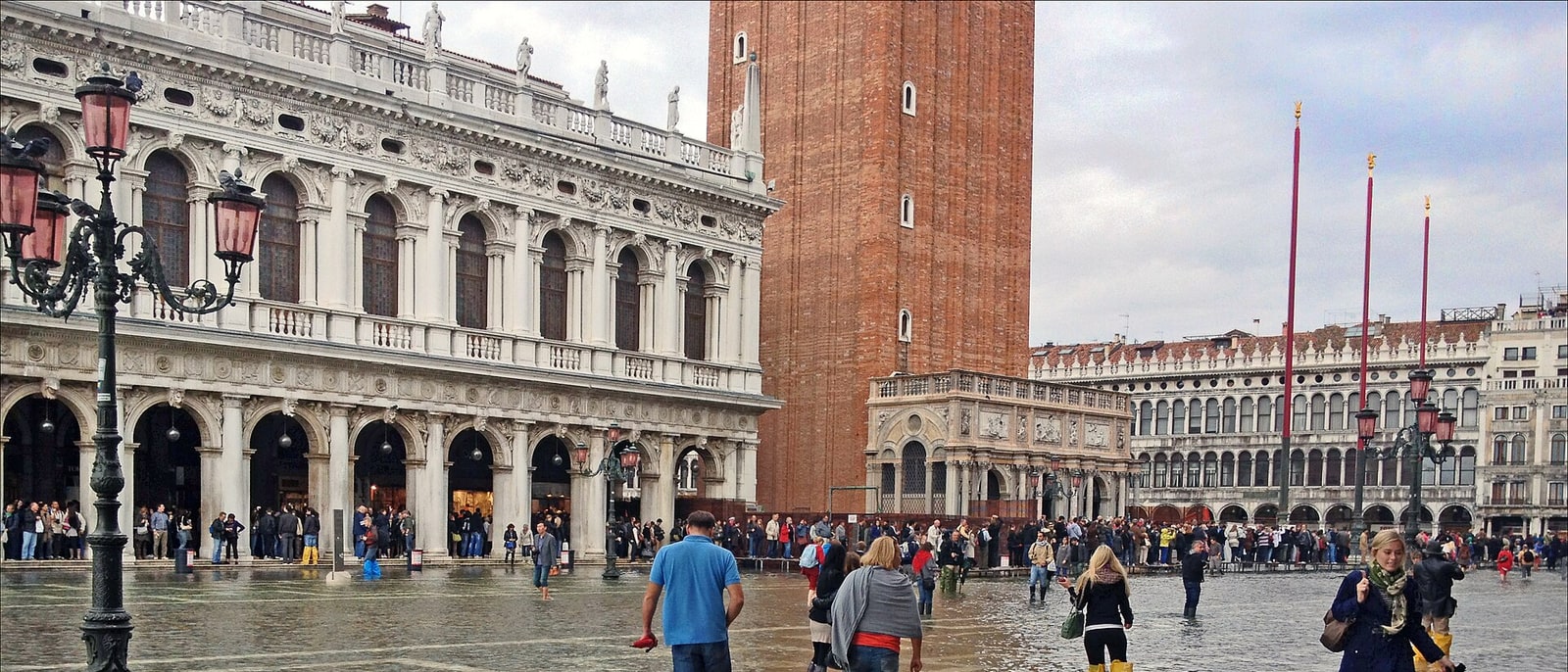St Mark’s Square with acqua alta, people walking through the water